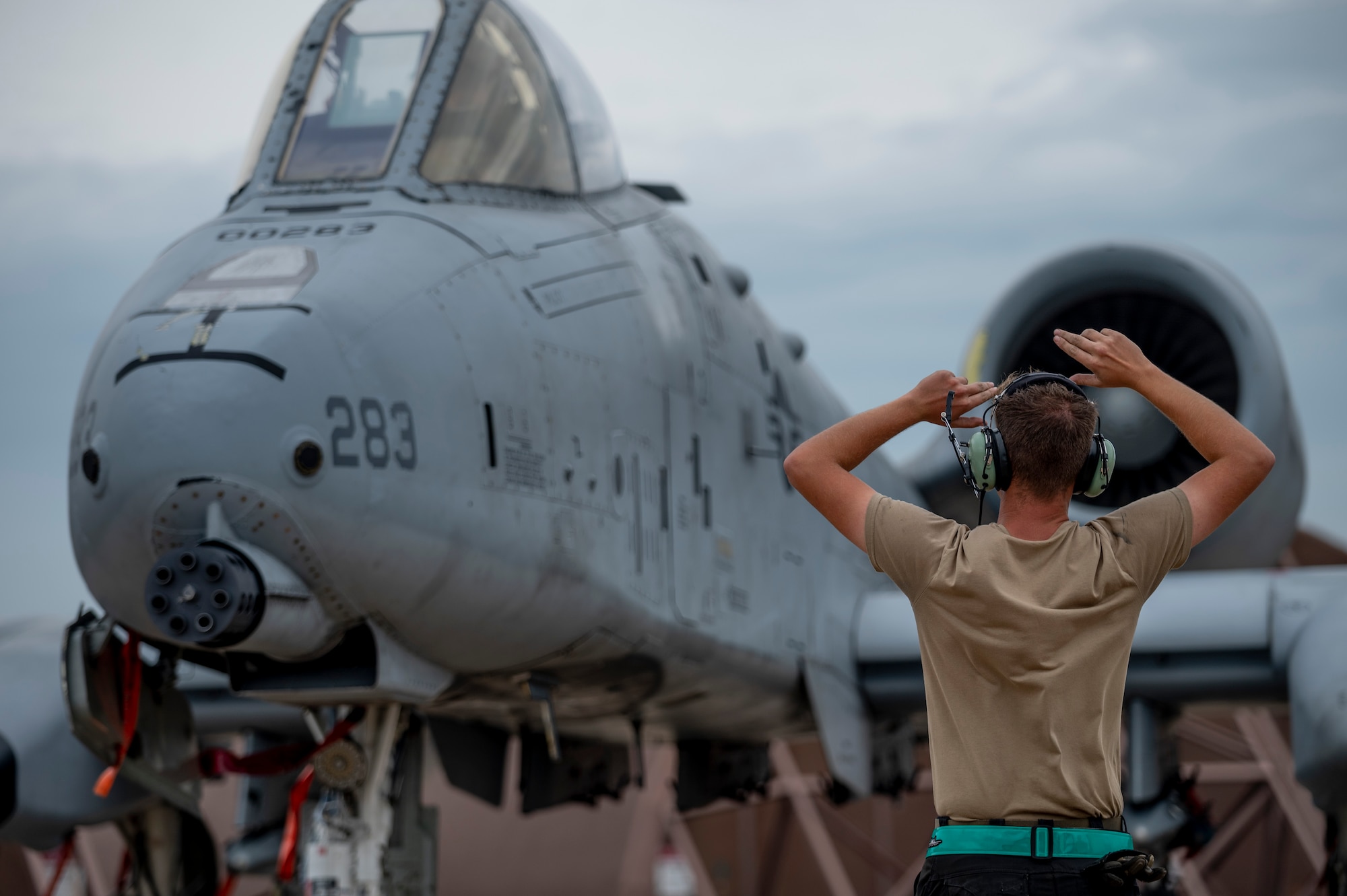 U.S. Air Force Airman 1st Class Tyler Enos, 25th Fighter Generation Squadron crew chief, guides an A-10 Thunderbolt II at Osan Air Base, Republic of Korea, Aug. 28, 2023.