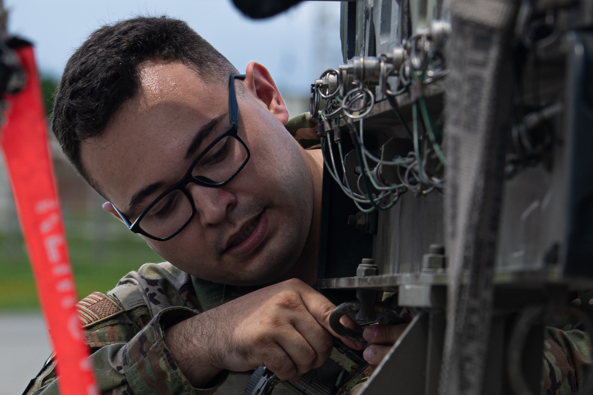 technician, prepares to load weaponry onto an F-15E Strike Eagle during a weapons load competition