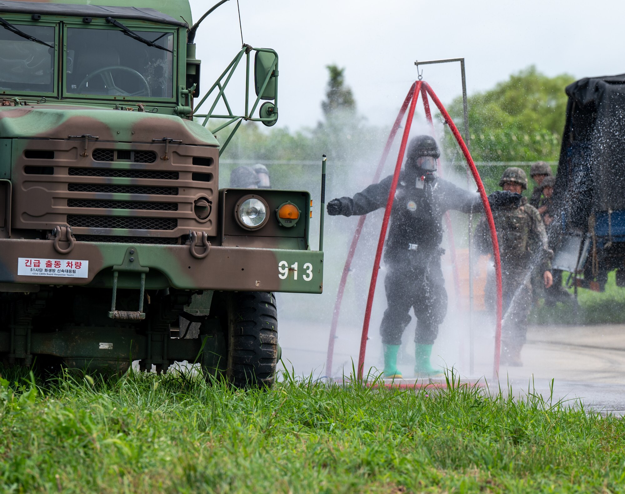 Republic of Korea Army Sgt. Lee Do Yoon simulates decontamination of a hazardous materials suit during a combined forces training at Osan Air Base, ROK, Aug. 24. 2023.