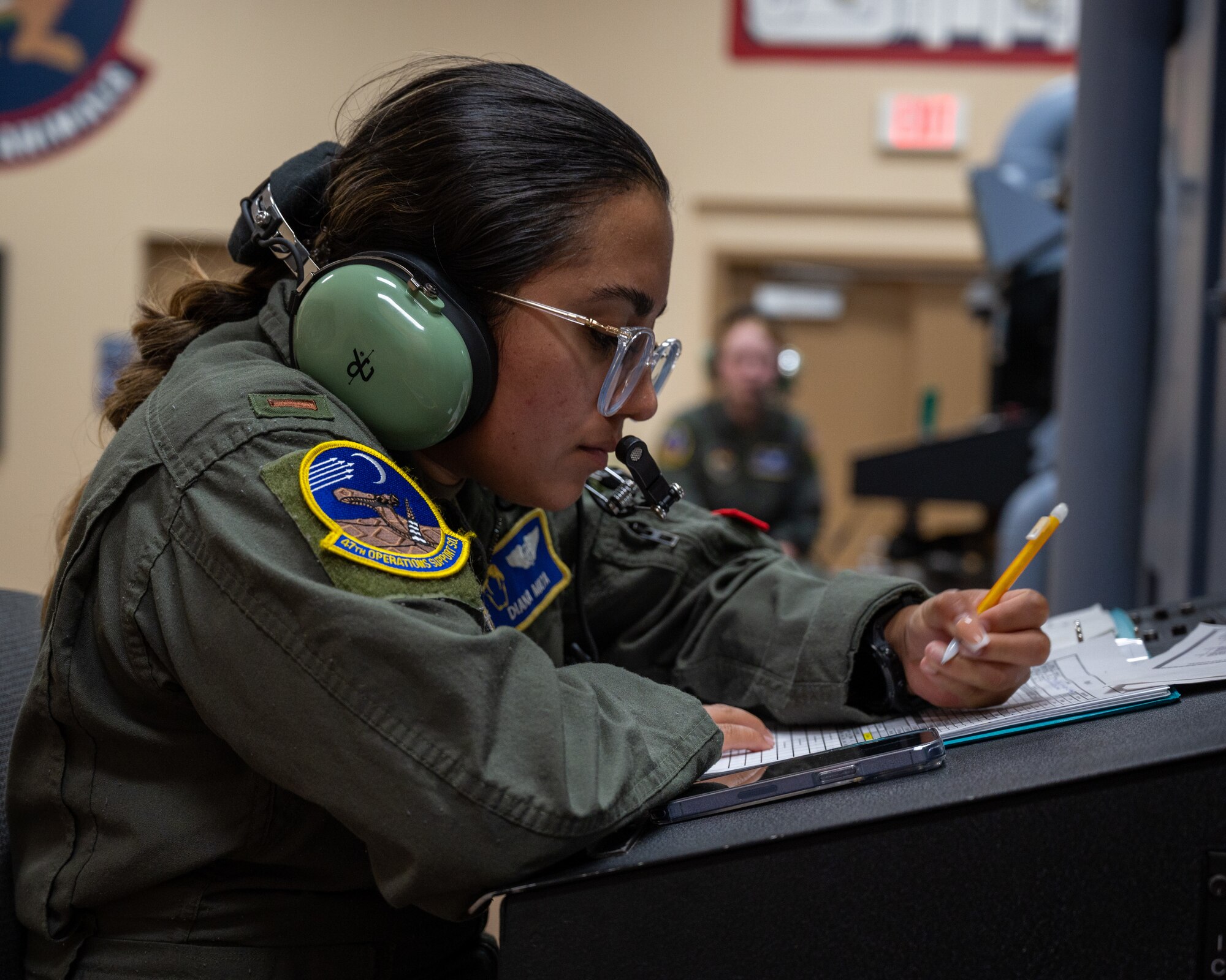 U.S. Air Force 2nd Lt. Diana Mata, a 47th Operations Support Squadron aerospace physiologist, notates the status of the members inside the altitude chamber at Laughlin Air Force Base, Texas, Aug. 14, 2023. Technicians use cameras, windows, and microphones inside the chamber to keep surveillance on the members inside, watching for signs of sickness. (U.S. Air Force photo by Senior Airman Nicholas Larsen)