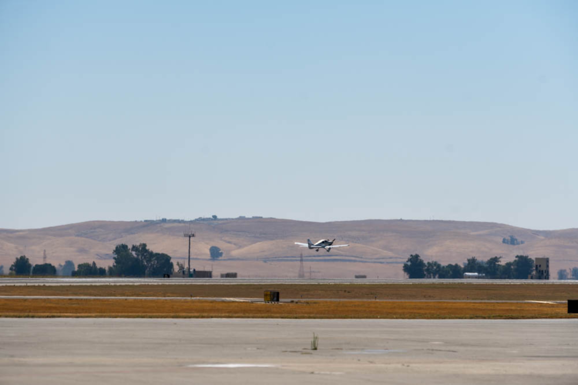 a small plane takes off from runway