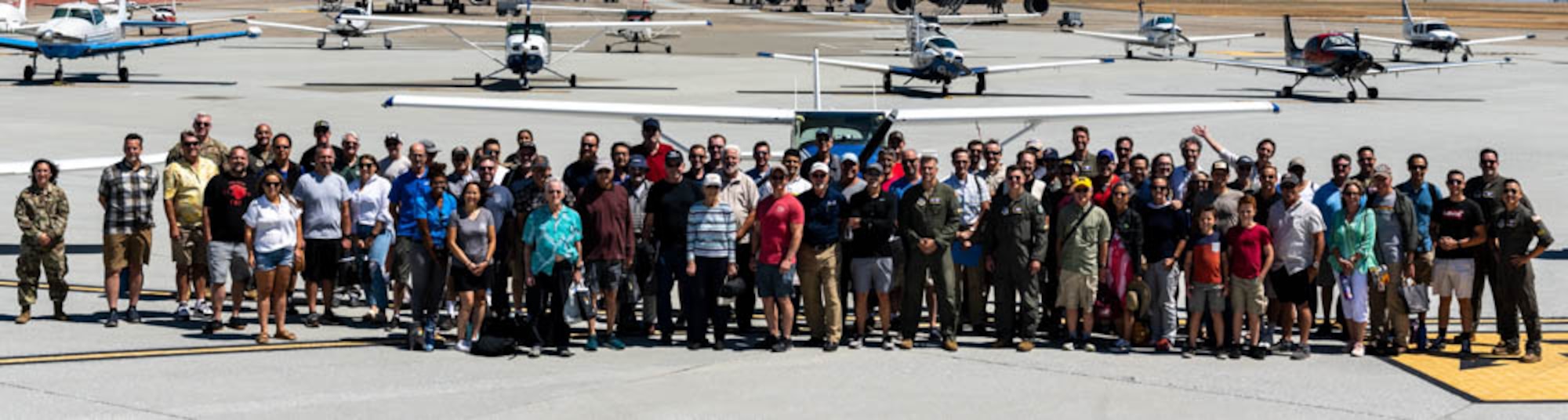 group stands in front of planes