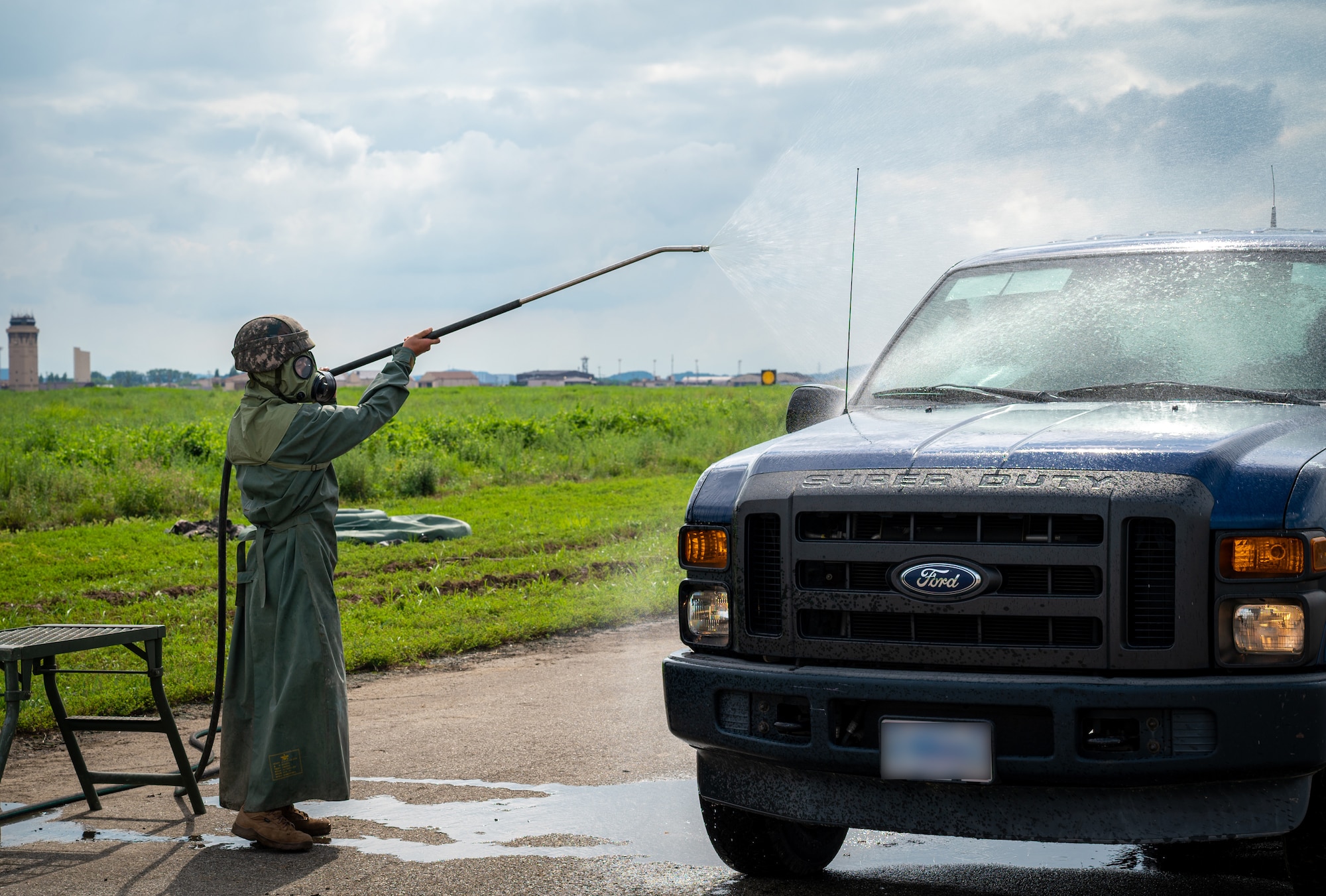 A Republic of Korea Army Soldier sprays a vehicle with a simulated decontamination agent during a combined forces training at Osan Air Base, ROK, Aug. 24. 2023.