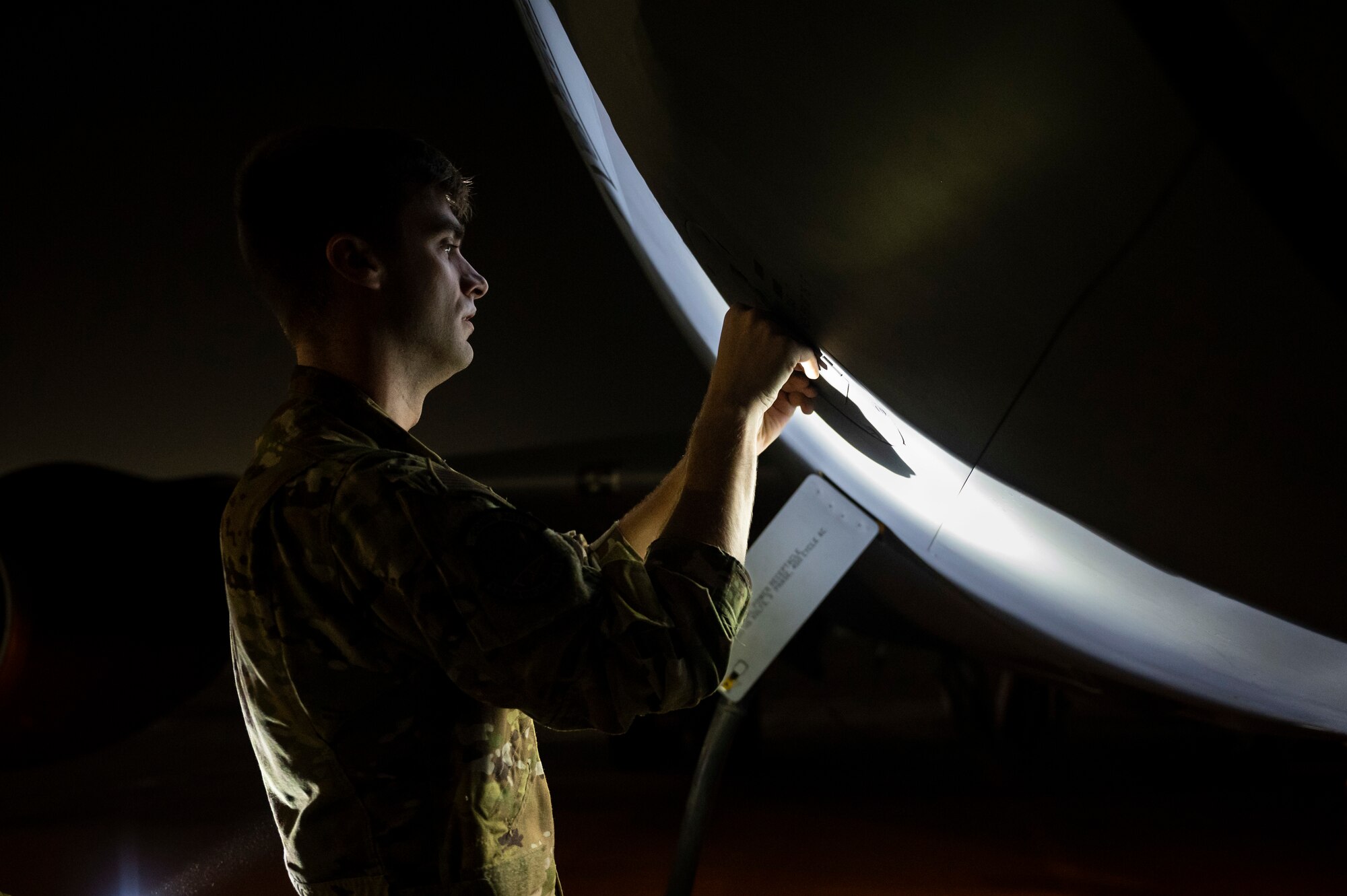 Airman working on an aircraft at night
