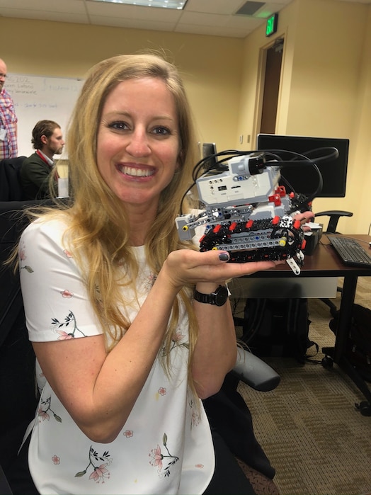  Woman holding robot and smiling
