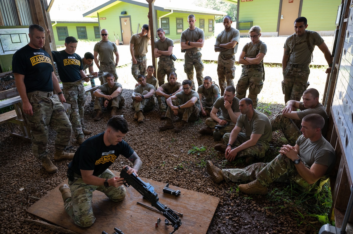 Ranger Assessment Course students learn how to take apart and name the main components of different weapons systems, May 29, 2023, Schofield Barracks, Hawaii. Truly representing a joint force, there were service members from numerous Air and Space Force Specialty Codes and Army Military Occupational Specialties in the RAC. It ranged from Army infantry to Air Force medics and Space Force developmental engineer and included career fields like engineer officer, military police, contracting, security forces and others. (U.S. Air Force photo by Tech. Sgt. Hailey Haux)