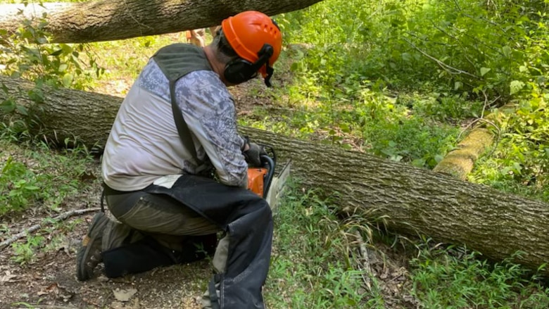 Upper Cumberland Southern Off-Road Bicycle Association Volunteer Kenny Crossman works hard Aug. 19, 2023, to remove a downed tree from Bear Wheels Mountain Bike Trail at Cordell Hull Lake in Carthage, Tennessee. (USACE Photo by Park Ranger Stone Fagan)