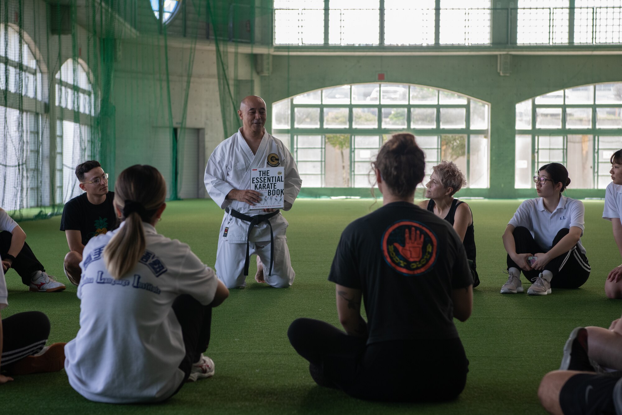 A karate instructor gives an explains the history of the martial art.