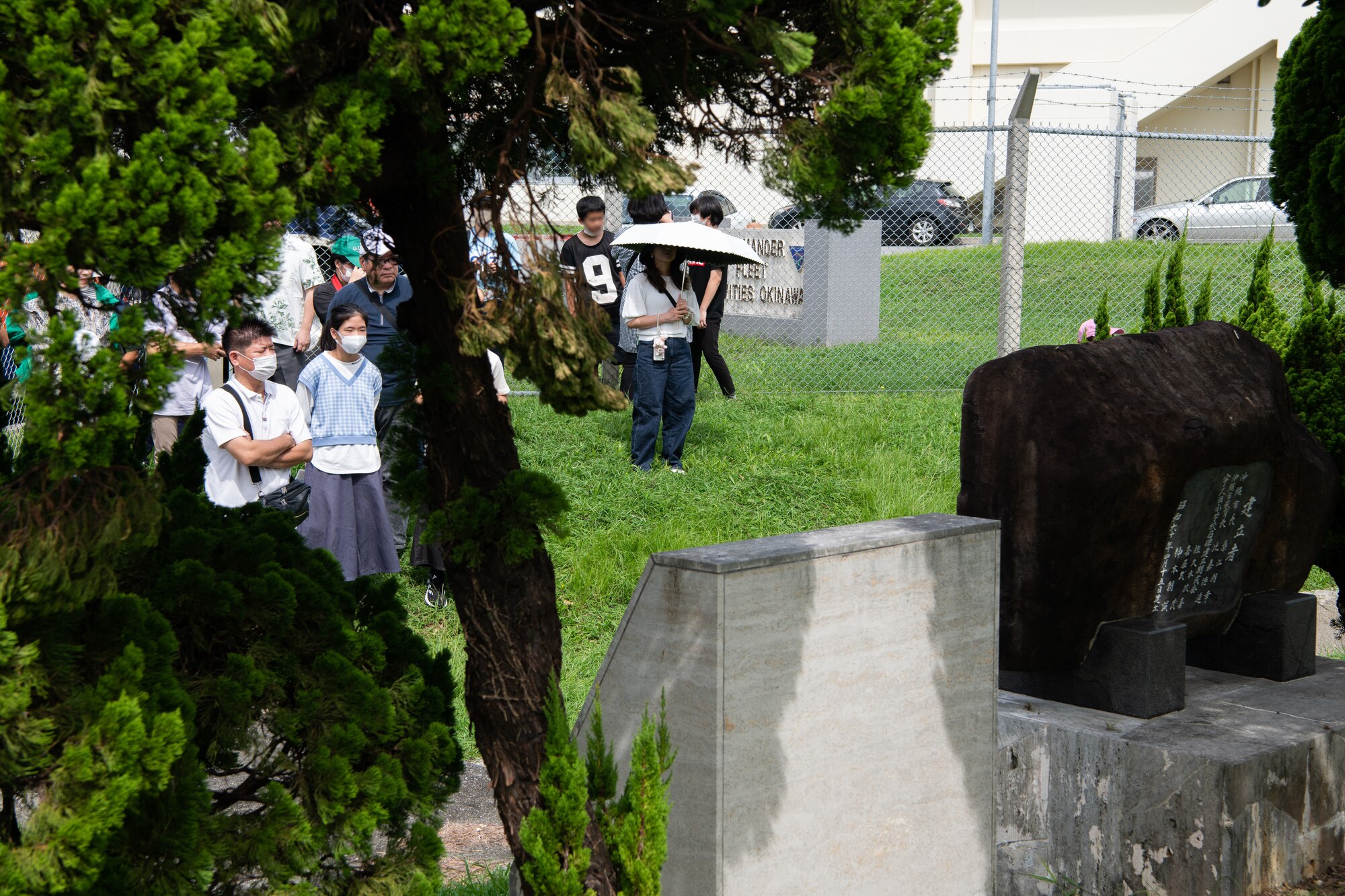 Okinawan residents read a plaque.