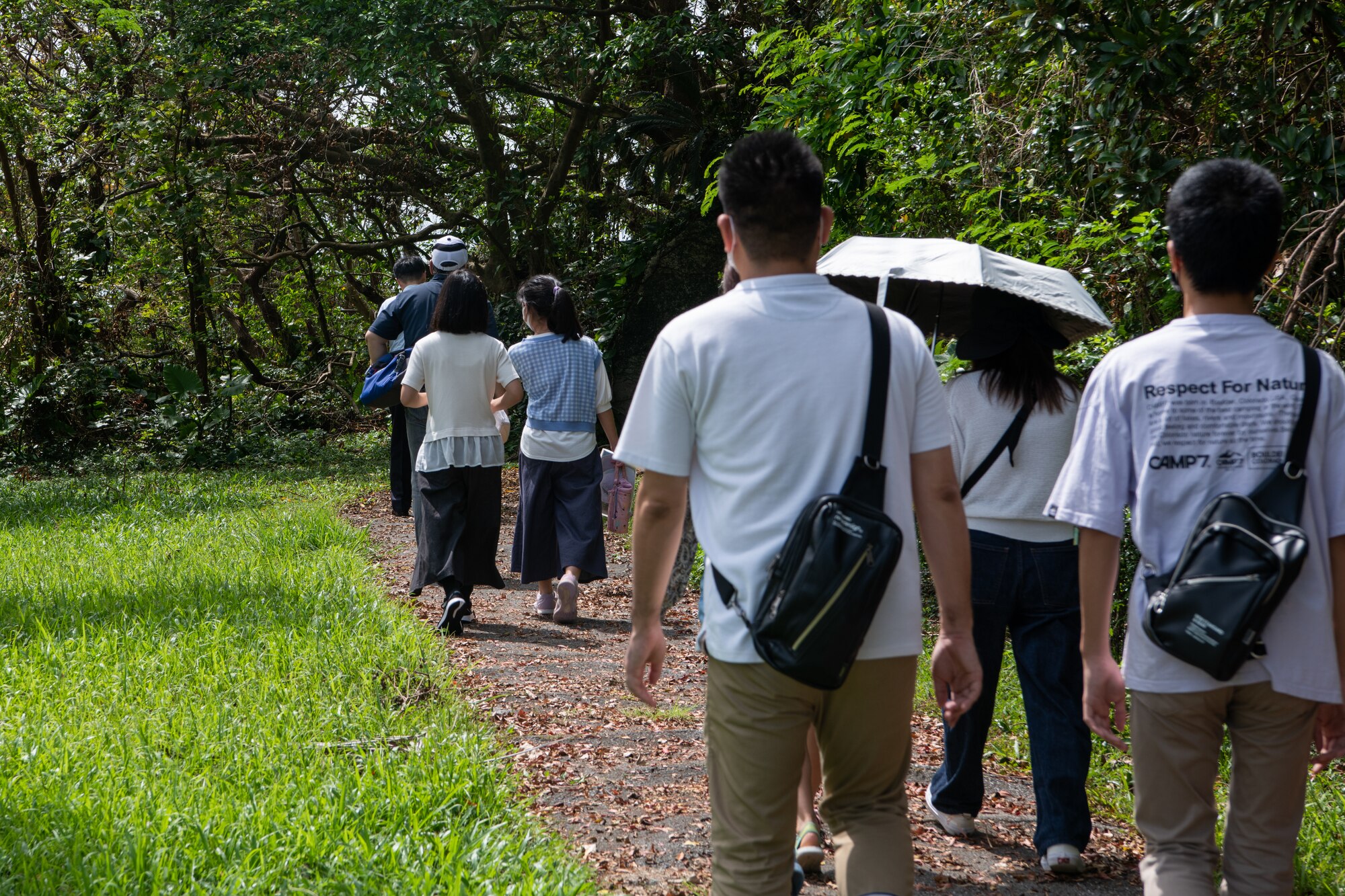 Okinawan residents walk a trail.