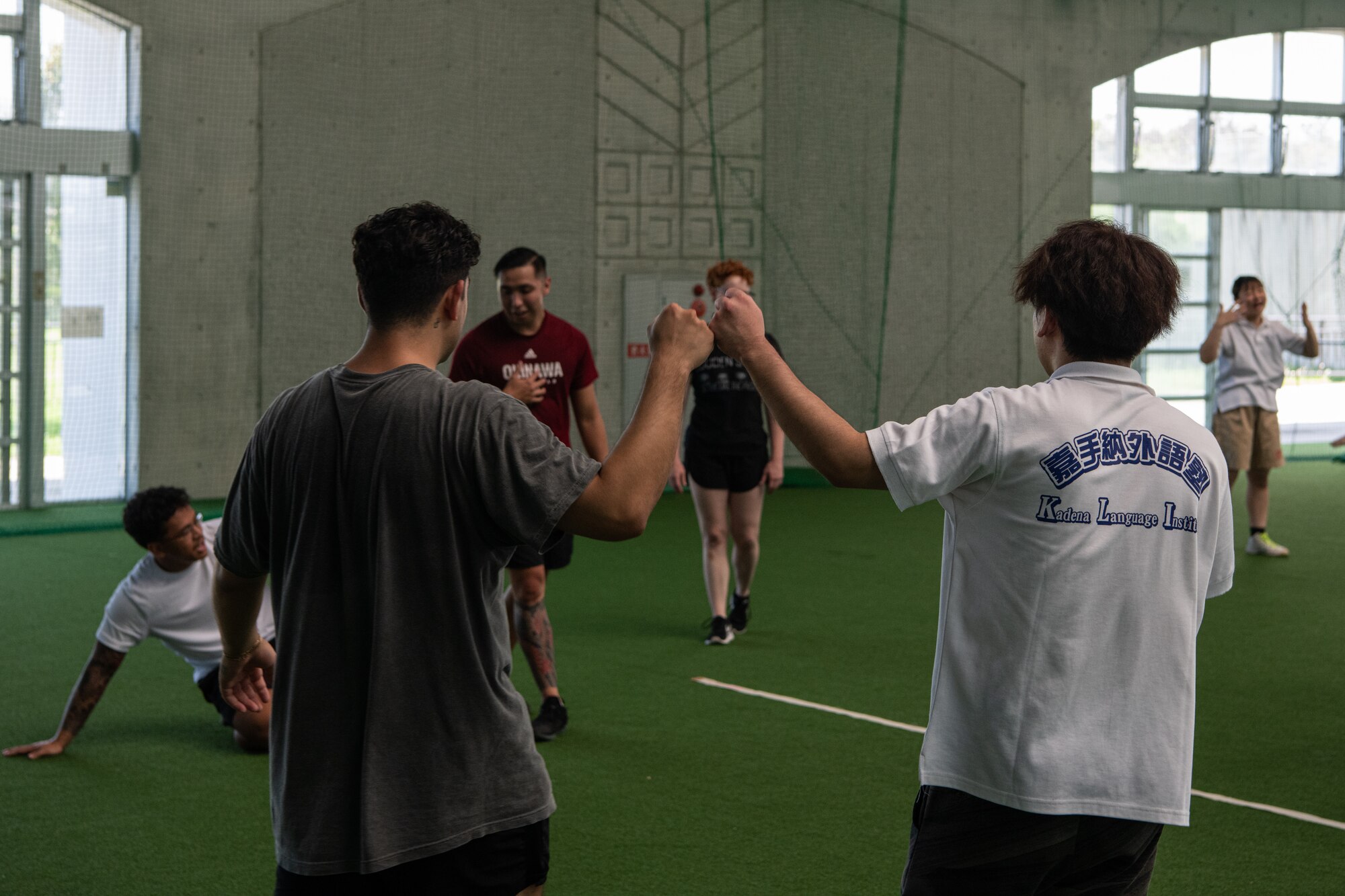 A volunteer and local student fist bump.