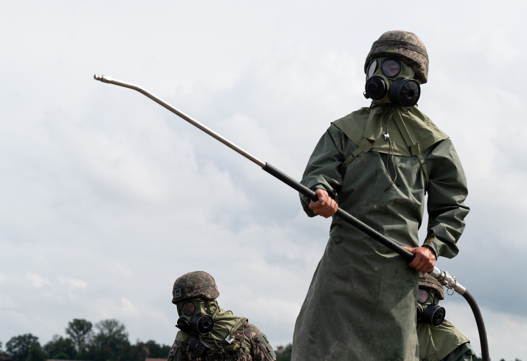 A Republic of Korea Army soldier simulates decontamination of a vehicle during combined forces chemical, biological, radiological and nuclear training with the 51st Civil Engineer Squadron at Osan Air Base, ROK, Aug. 24, 2023. ROK Army and Air Force partnered with Airmen from the 51st CES to enhance their ability to decontaminate zones, vehicles, equipment and personnel under a potential CBRN threat. (U.S. Air Force photo by Airman 1st Class Chase Verzaal)