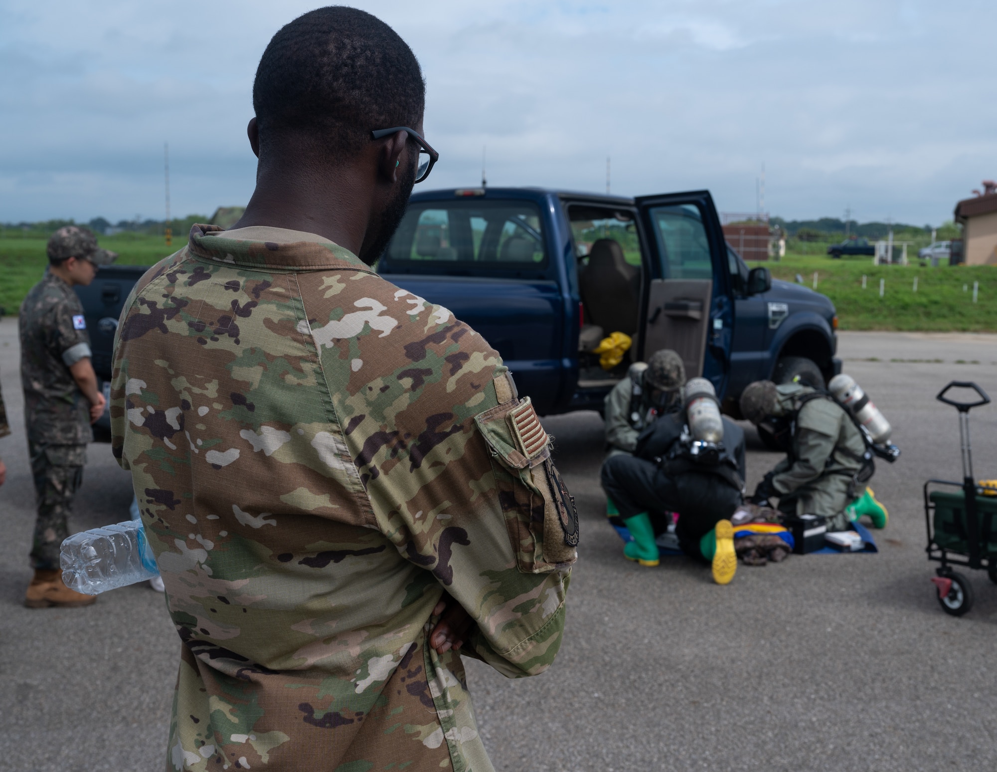 U.S. Air Force Senior Airman Kevin Lancaster, 51st Civil Engineer Squadron emergency manager, oversees Republic of Korea Air Force airmen during combined forces chemical, biological, radiological and nuclear training with the 51st Civil Engineer Squadron at Osan Air Base, ROK, Aug. 24, 2023. ROK forces practiced different steps of the decontamination process to ensure mission readiness in the event of a real-world scenario. (U.S. Air Force photo by Airman 1st Class Chase Verzaal)