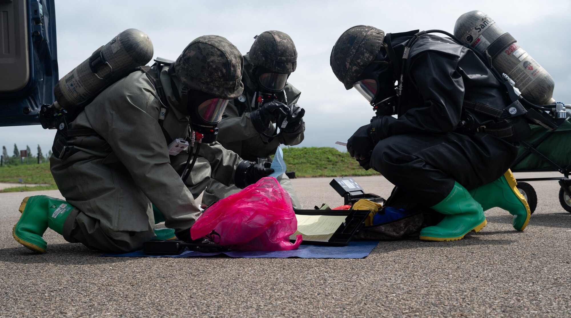 Republic of Korea Air Force airmen record simulated contamination data during combined forces chemical, biological, radiological and nuclear training with the 51st Civil Engineer Squadron at Osan Air Base, ROK, Aug. 24, 2023. 51st CES emergency managers partnered with ROK Air Force and Army service members to practice emergency response procedures and enhance their readiness for real-world threats. (U.S. Air Force photo by Airman 1st Class Chase Verzaal)