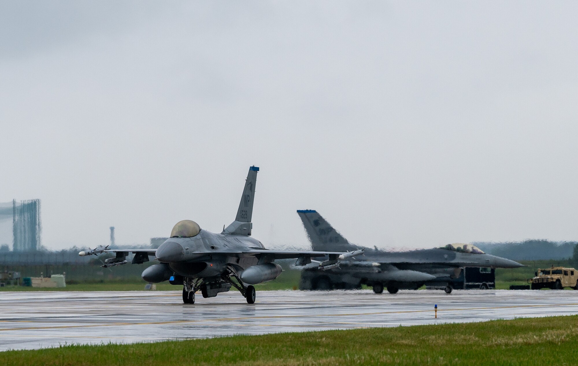 Two U.S. Air Force F-16 Fighting Falcons assigned to the 8th Fighter Wing taxi down the runway.