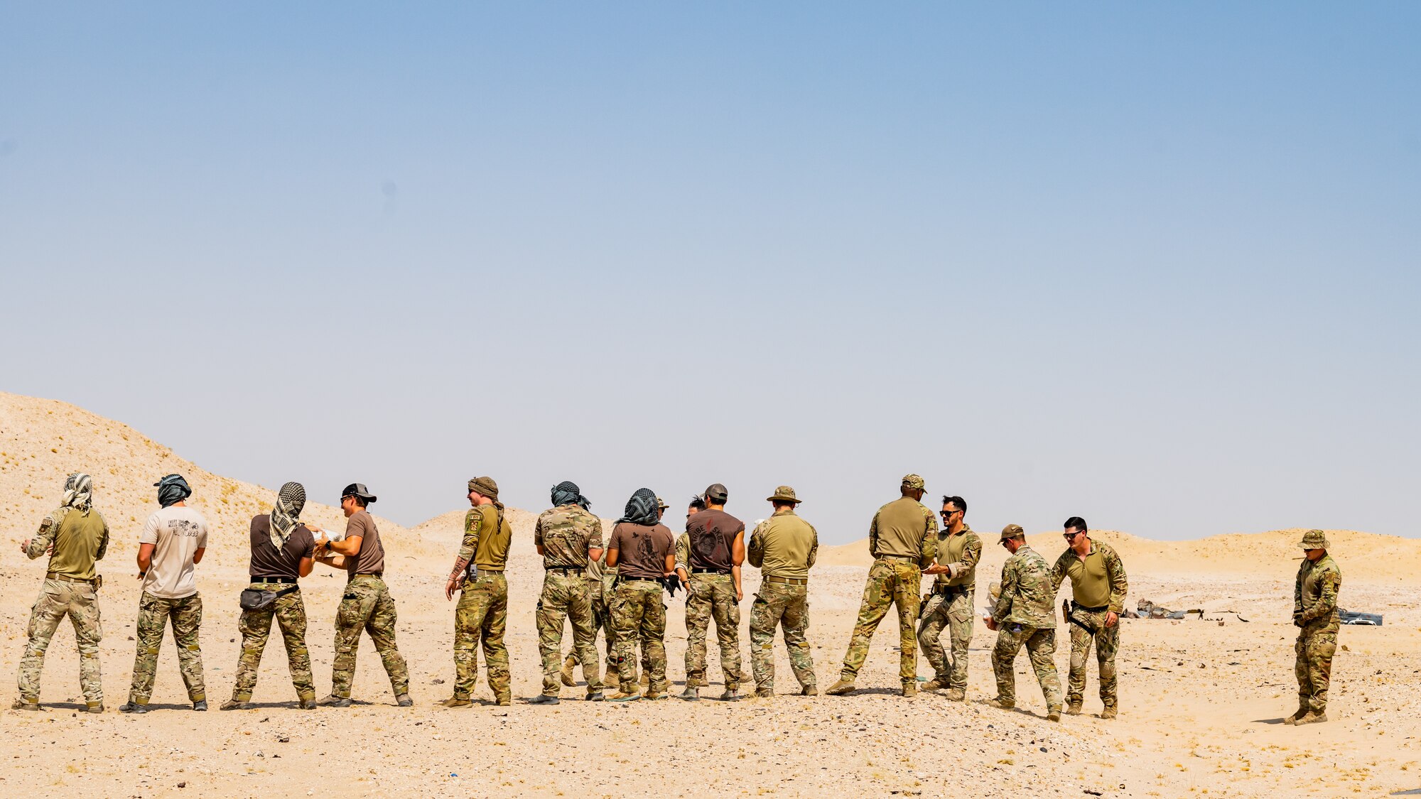 U.S. Army, U.S. Air Force, and U.S. Navy explosive ordnance disposal technicians from across Kuwait unload explosives and expired munitions in preparation for a large-scale detonation during Operation Solar Flare at Udairi Range, Kuwait, Aug. 24, 2023. Solar Flare is a 5-day, joint-service field training exercise developed and hosted by the 386th and 332nd Expeditionary Civil Engineer Squadron’s EOD teams that brought together 30 Army, Navy, and Air Force personnel for a series of intense training scenarios focused on working together through current and emerging threats in the CENTCOM AOR. (U.S. Air Force photo by Staff Sgt. Kevin Long)