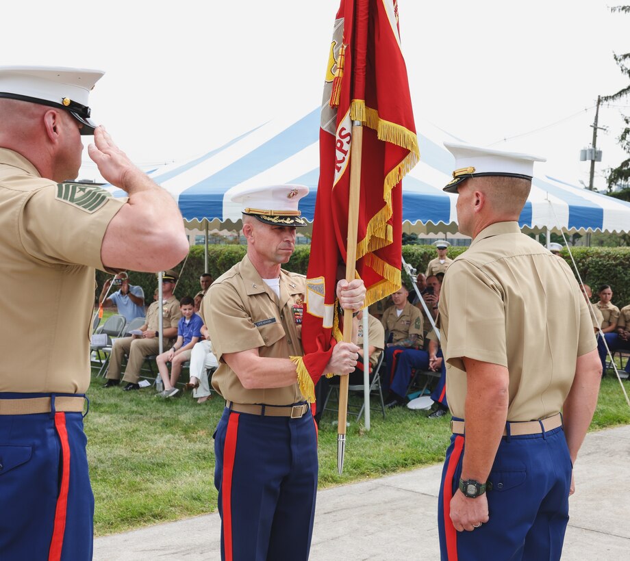 U.S. Marine Corps Col. Timothy Dremann, middle, passes the colors to Col. Richard Robinson III, right, during the change of command ceremony at 4th Marine Corps District (4MCD) headquarters in New Cumberland, Pennsylvania, August 21, 2023. During the ceremony, Dremann relinquished his duties as the commanding officer of 4MCD to Robinson. (U.S. Marine Corps photo by Cpl. Bernadette Pacheco)