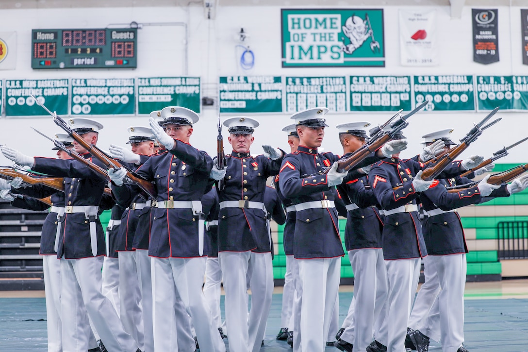 Marines with the Silent Drill Platoon execute their drill sequence during a performance at Cary High School, North Carolina, July 31, 2023. The Battle Color Detachment had the honor of performing for over 300 guests showcasing precision and discipline (U.S. Marine photo by Sgt. Brandon Salas)
