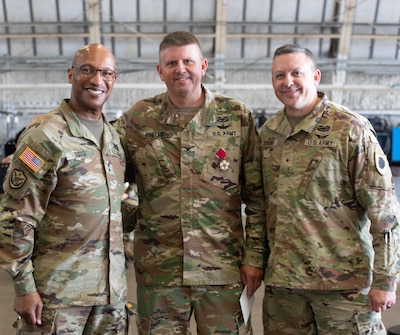 Maj. Gen. Rodney Boyd, Assistant General Adjutant General - Army and Commander of the Illinois Army National Guard, Brig. Gen. Justin Osberg, deputy assistant Adjutant General - Army,  and Col. Jason Osberg, 65th Troop Command commander take a group photo during the change of command ceremony Aug. 27, 2023 at the Army Aviation Support Facility in Peoria, Illinois.