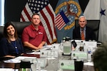 People seated at a conference table.