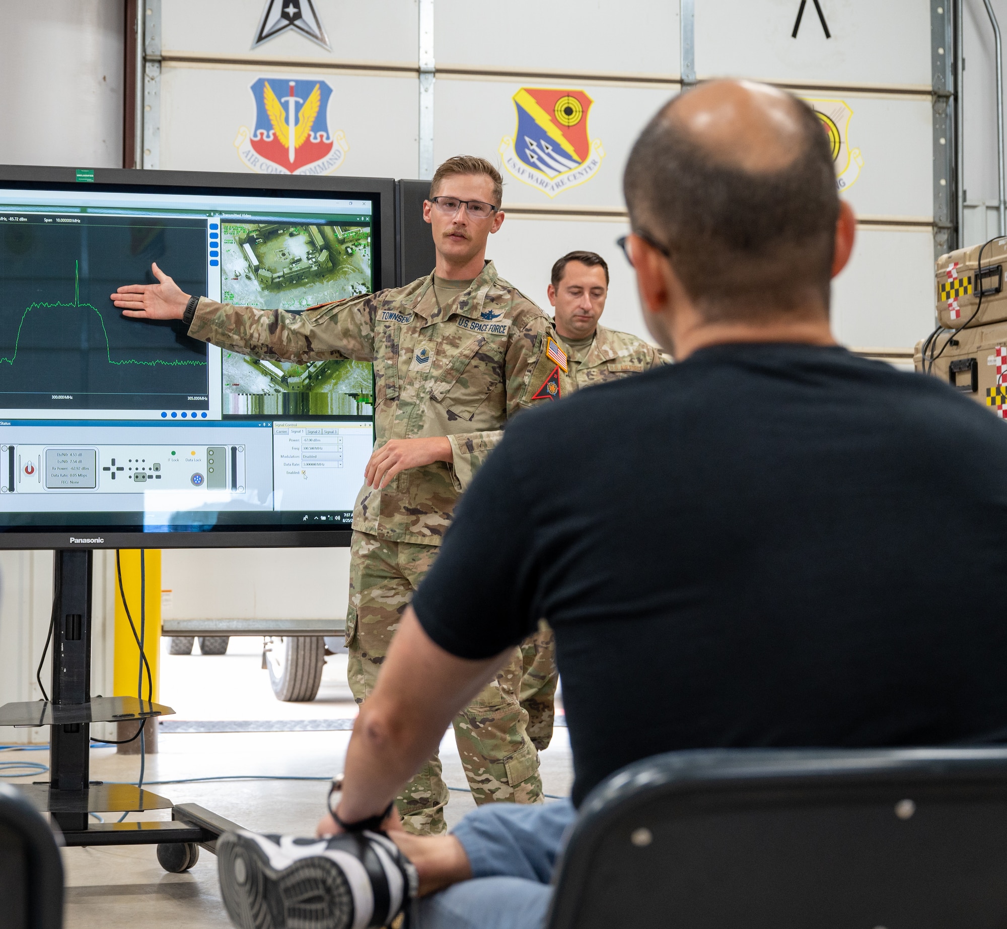 James Murray sits during a brief about signal jamming from a U.S. Space Force service member from the 527th Space Aggressor Squadron.