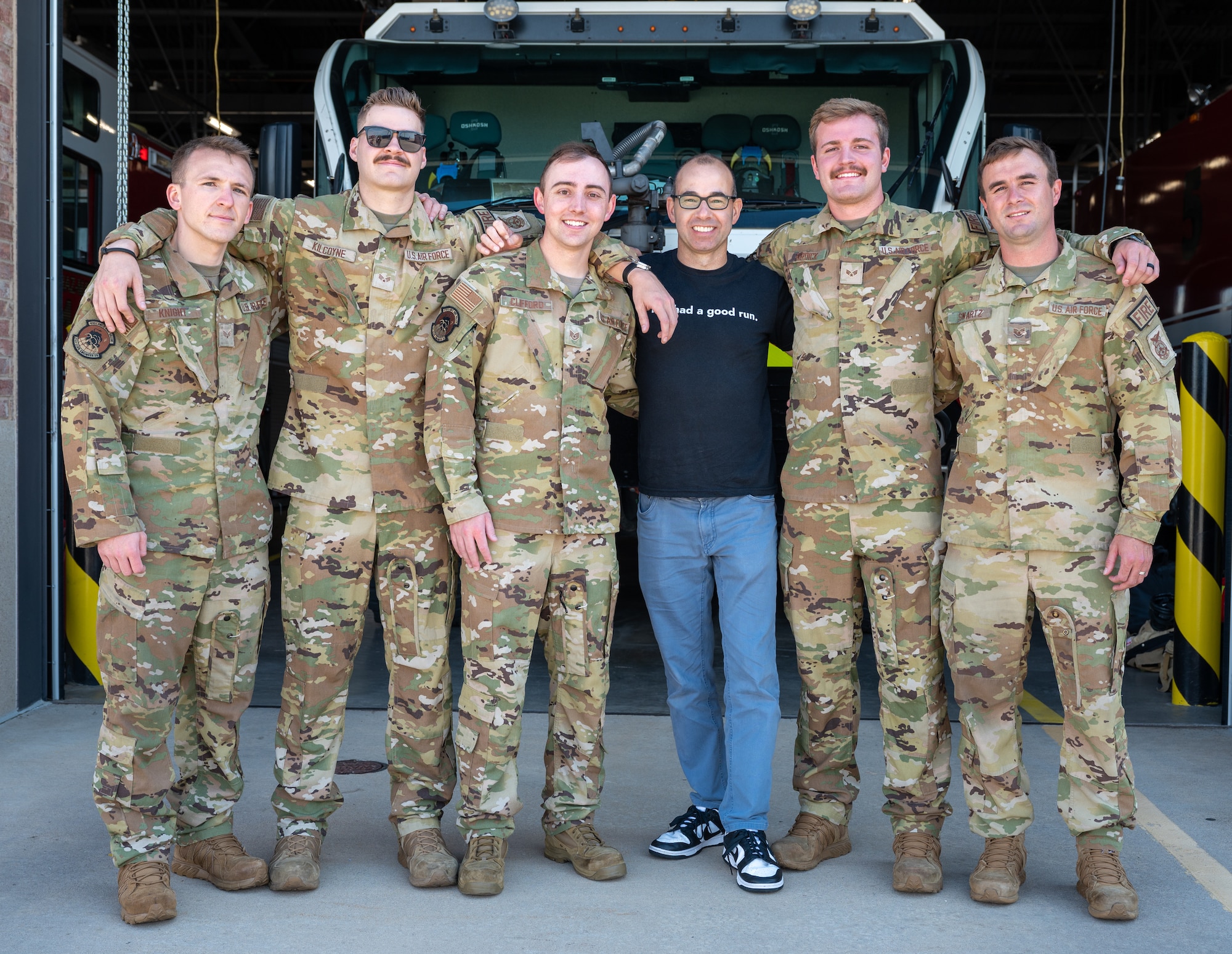 A group of U.S. service members with the 21st Civil Engineer Squadron pose for a photo with James Murray.