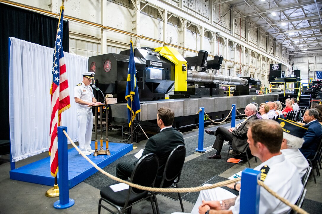Capt. JD Crinklaw, commander, Puget Sound Naval Shipyard & Intermediate Maintenance Facility, pays tribute to Special Warfare Operator 1st Class (Navy SEAL) Patrick D. Feeks during a special lathe dedication ceremony Aug. 12, 2023, in Rochester, N.Y. Feeks was killed in Afghanistan Aug. 16, 2012.