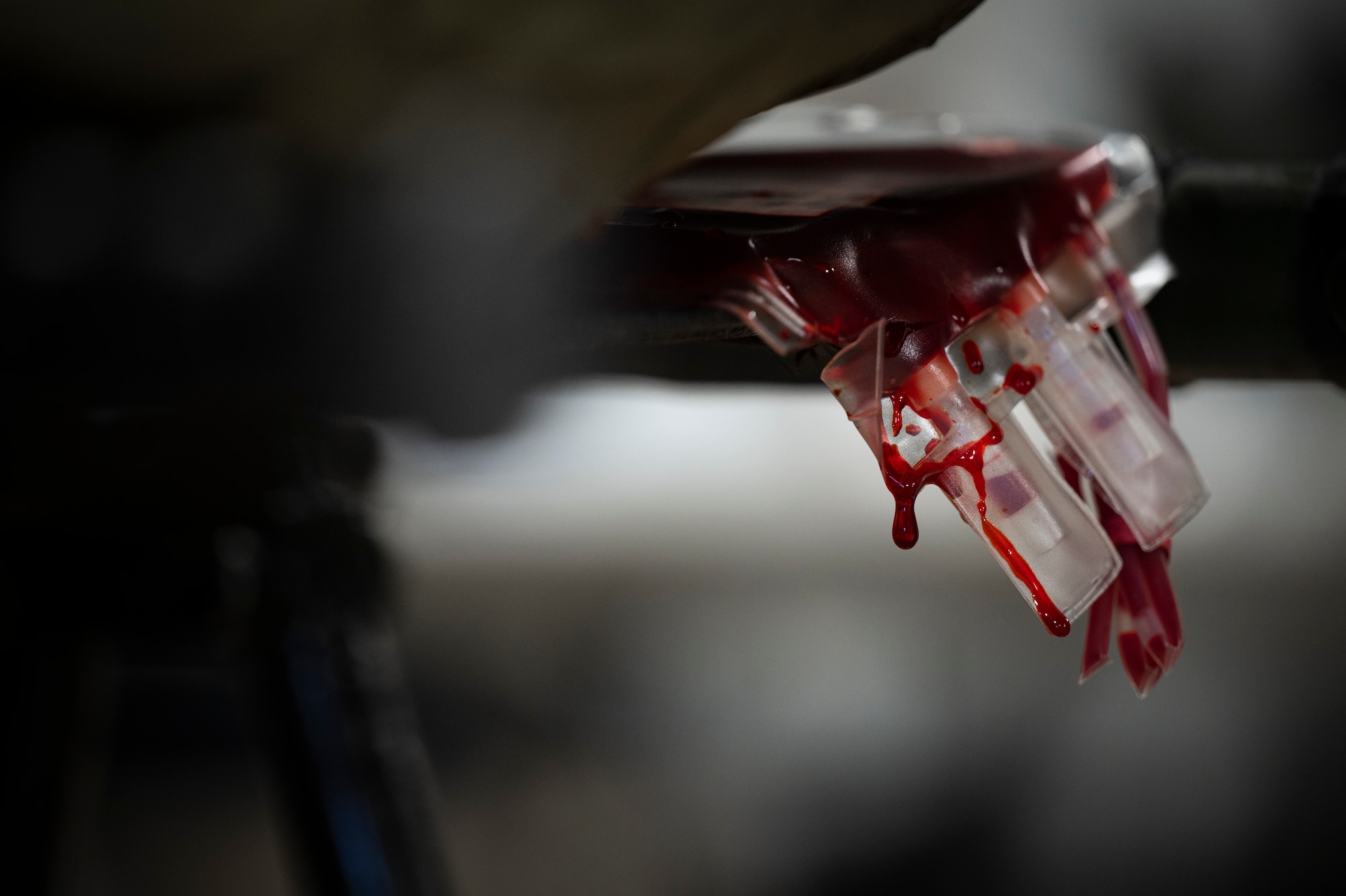 Fake blood drips from a blood bag.
