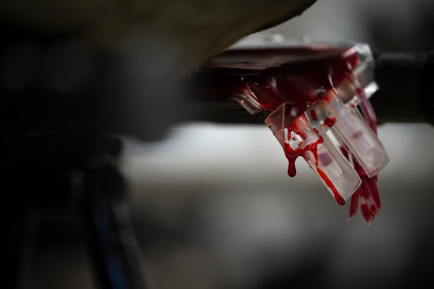 Fake blood drips from a blood bag.