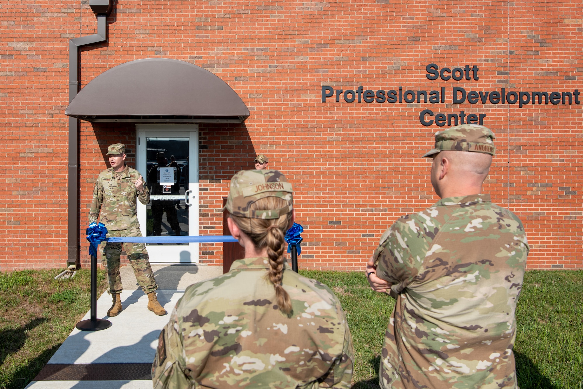 A man speaks about the development center during a ribbon cutting ceremony.