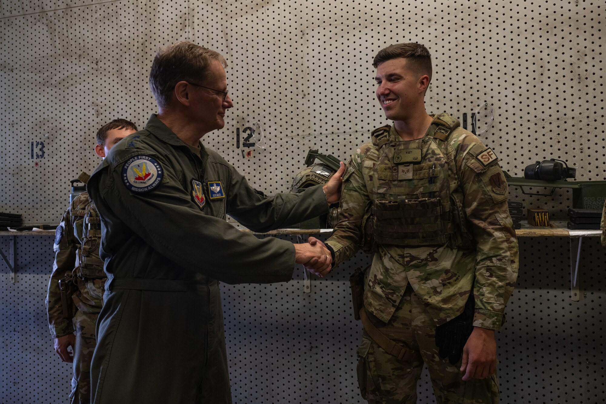 An Airman assigned to the 4th Security Forces Squadron shakes hands with Lt. Gen. Russ L. Mack, the deputy commander of Air Combat Command, during a base tour at Seymour Johnson Air Force Base, North Carolina, Aug. 24, 2023. Mack visited several locations on base  to discuss the 4th Fighter Wing mission, its components, and quality of life across the Wing while also recognizing several Airmen for their performance and dedication to the fighter wing mission. (U.S. Air Force photo by Staff Sgt. Koby I. Saunders)
