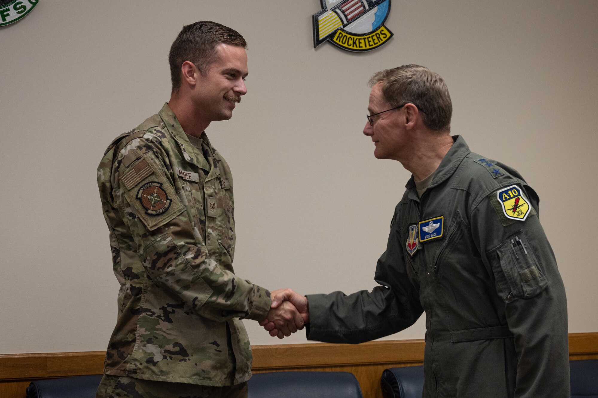 An Airman assigned to the 333rd Fighter Generation Squadron shakes hands with Lt. Gen. Russ L. Mack, the deputy commander of Air Combat Command, during a base tour at Seymour Johnson Air Force Base, North Carolina, Aug. 24, 2023. Mack visited several locations on base  to discuss the fighter wing mission, its components, and quality of life across the Wing while also recognizing several Airmen for their performance and dedication to the fighter wing mission. (U.S. Air Force photo by Staff Sgt. Koby I. Saunders)