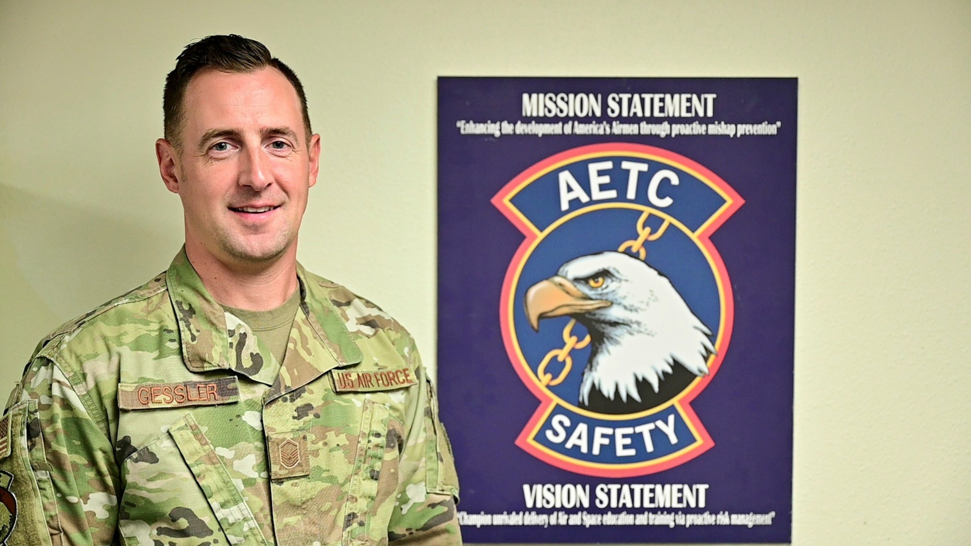 MSgt Gessler poses in front of a AETC Safety sign
