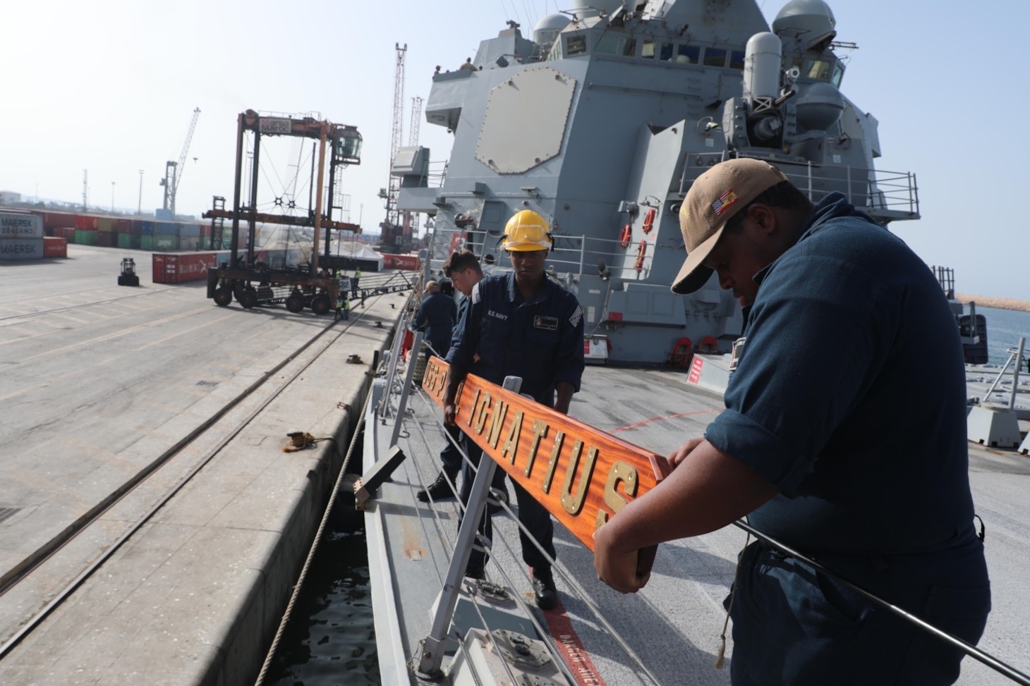 Sailors assigned to the Arleigh Burke-class guided-missile destroyer USS Paul Ignatius (DDG 117), hang the ship’s sign after pulling into Morocco, Aug. 25, 2023. Paul Ignatius is on a scheduled deployment in the U.S. Naval Forces Europe area of operations, employed by the U.S. Sixth Fleet to defend U.S., allied and partner interests. (U.S. Navy photo by Mass Communication Specialist 1st Class Zac Shea)
