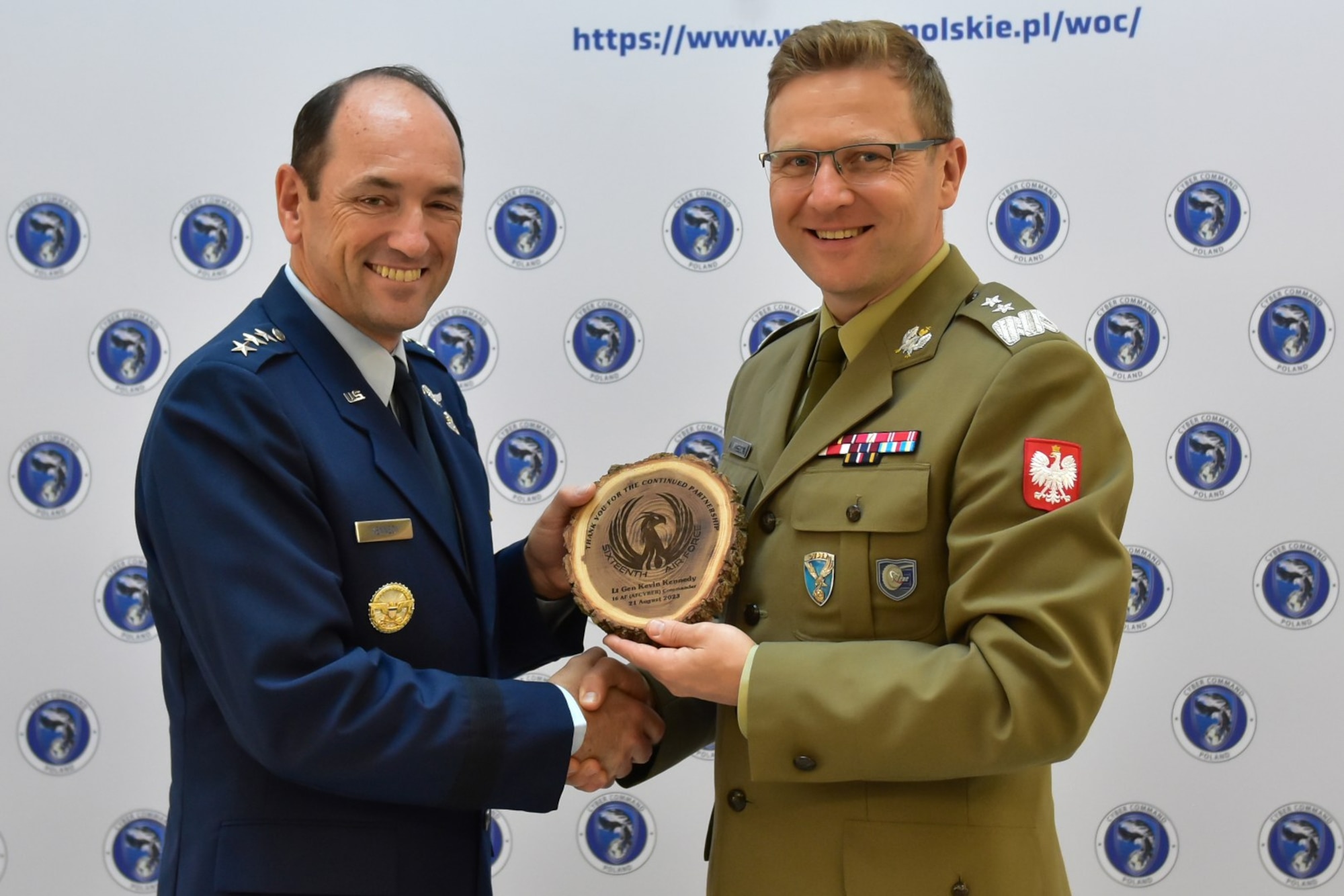 16th Air Force commander is posing with Poland Cyber Command commander.