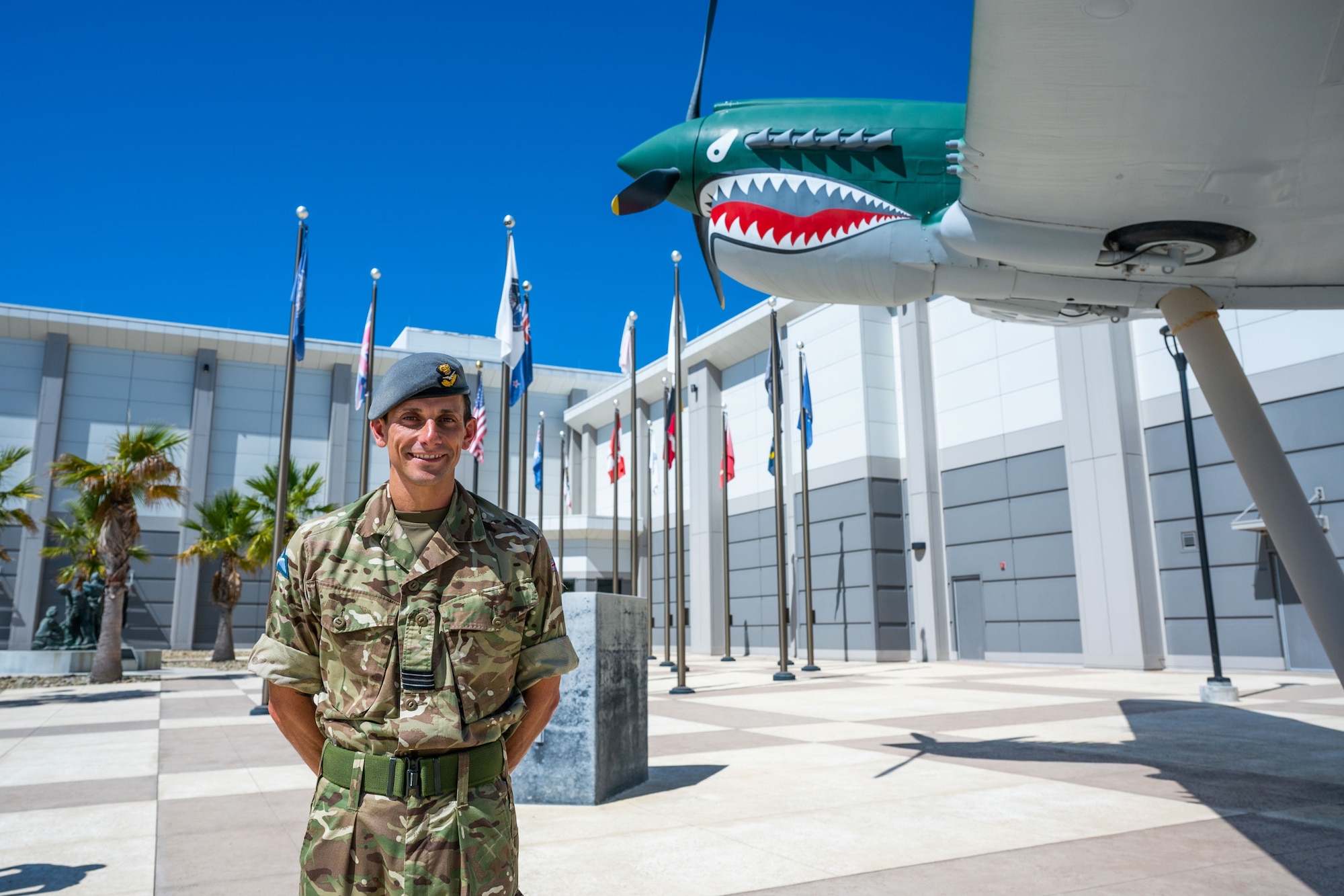 Flt. Lt. Christopher Atkin, Royal Air Force Space intelligence officer and Great Britain exchange officer, stands in front of the Combined Force Space Component Command headquarters, which is co-located with the Combined Space Operations Center (CSpOC) at Vandenberg Space Force Base, Calif., Aug. 29, 2023. Atkin, also serving as the Flight Commander of the Battlespace Intelligence Flight, Intelligence, Surveillance and Reconnaissance Division (ISRD), for the CSpOC, was the first coalition partner to complete the Senior Intelligence Duty Officer (SIDO) training course – an 80-hour academic course requisite aimed to teach the fundamentals for all SIDOs and tailored to accommodate coalition participants. (U.S. Space Force photo by Tech. Sgt. Luke Kitterman)