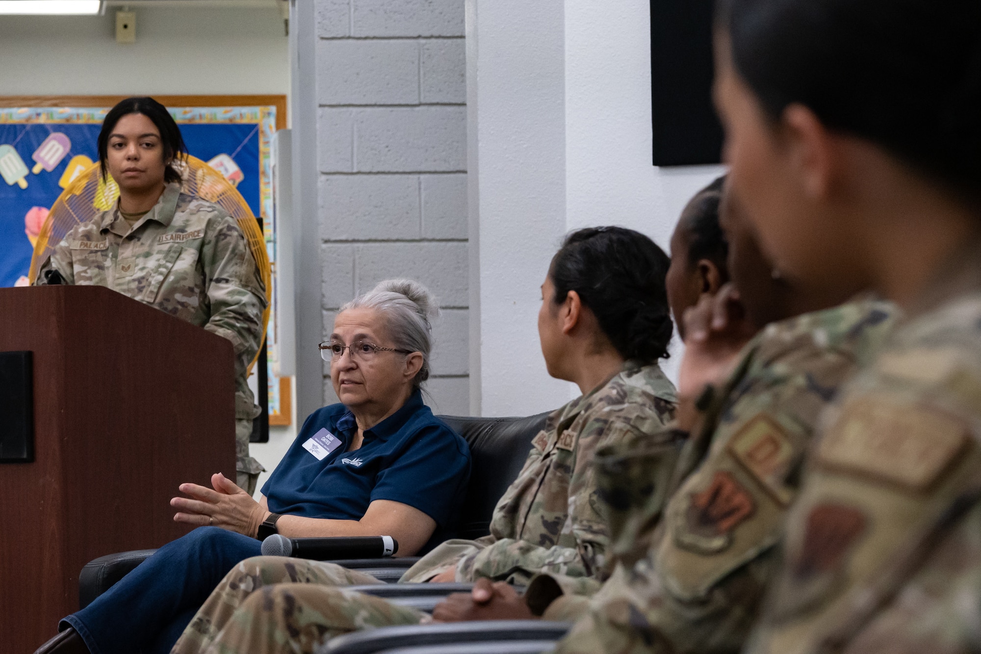 Ms. Bobi Oates, left of center, shares her experience as a woman in the Air Force.