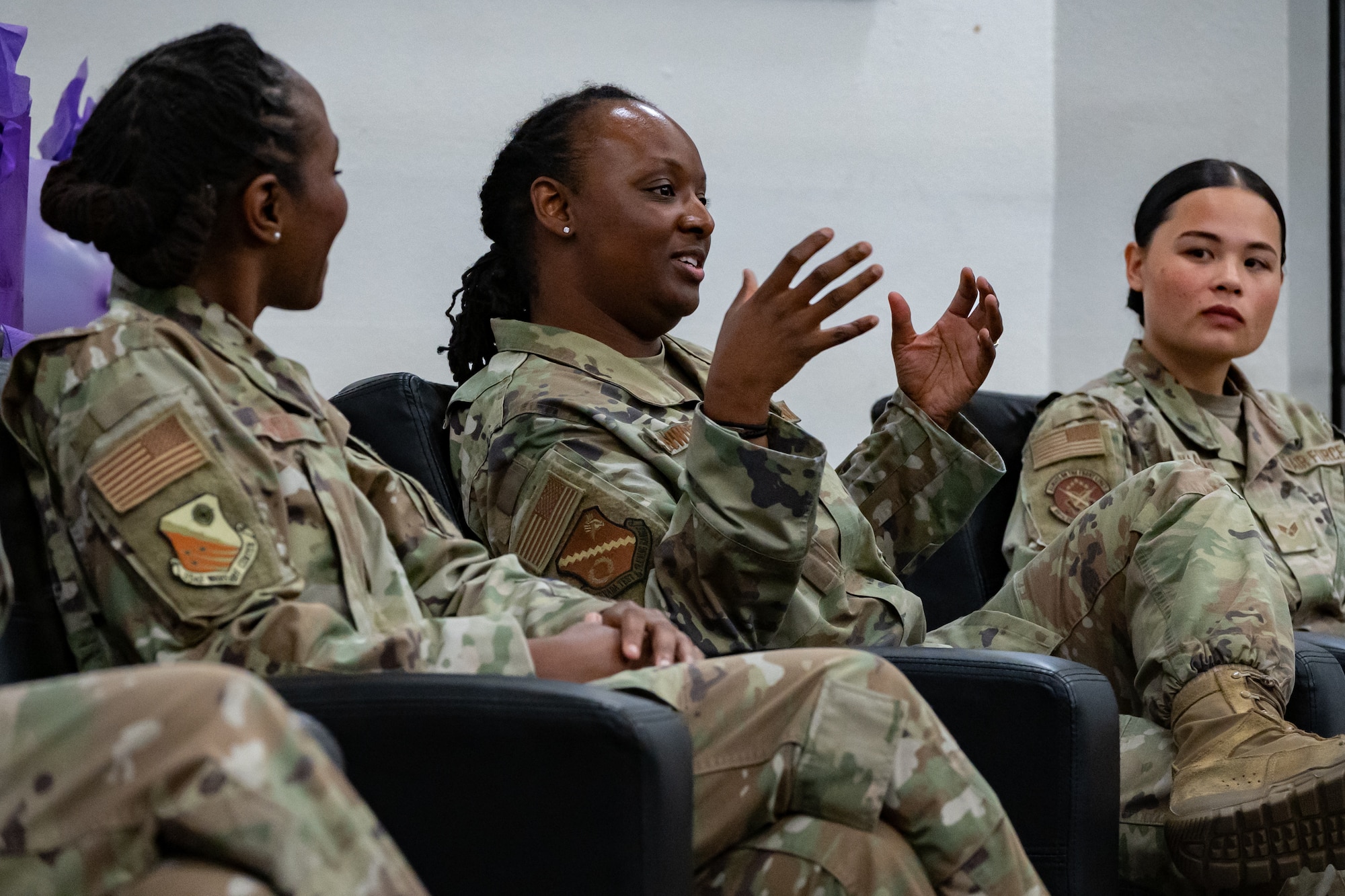 A panelist, center, shares her experience of being a woman in the Air Force.