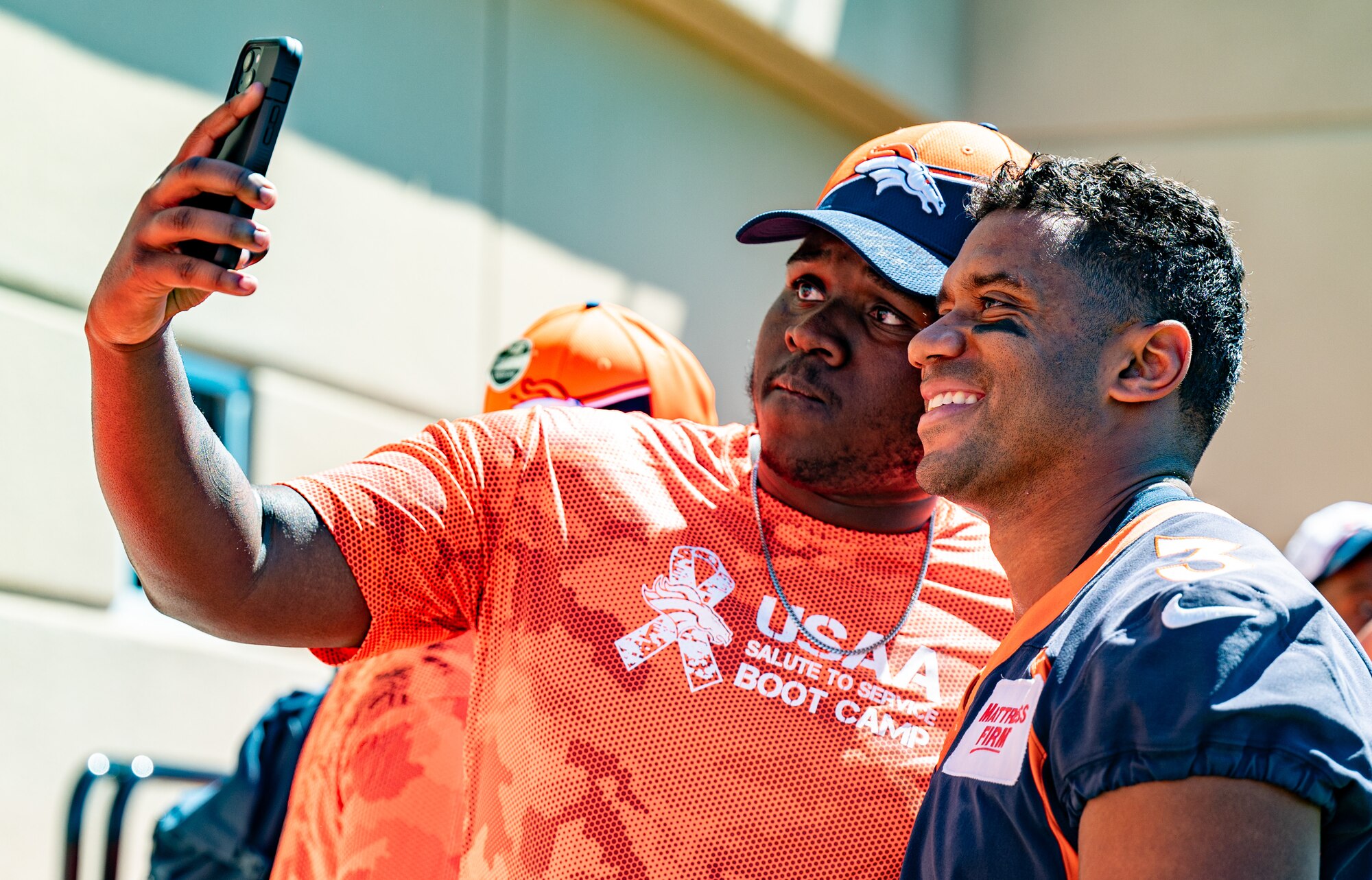 man taking selfie with Russell Wilson