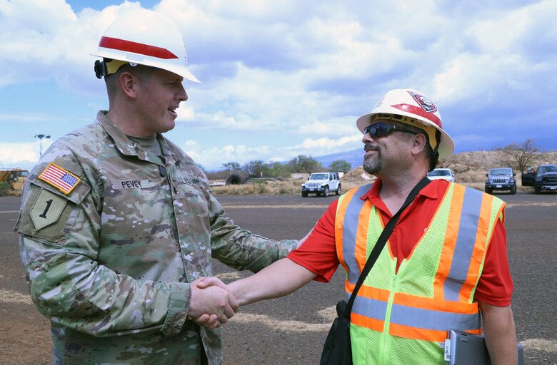 Lt. Col. Ryan C. Pevey, commander, Honolulu District, U.S. Army Corps of Engineers presents a coin to Kevin Bontomasi, a communication specialist from the Honolulu District Power Planning and Response Team on Maui, Aug. 28. The USACE is working with local, state and federal partners on a mission assignment from the Federal Emergency Management Agency in response to the Hawai’i Wildfires.