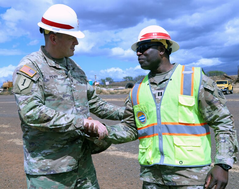 Lt. Col. Ryan C. Pevey, commander, Honolulu District, U.S. Army Corps of Engineers presents a coin to Capt. Walter Dezir, a mission liaison officer from the Honolulu District Power Planning and Response Team on Maui, Aug. 28. The USACE is working with local, state and federal partners on a mission assignment from the Federal Emergency Management Agency in response to the Hawai’i Wildfires.