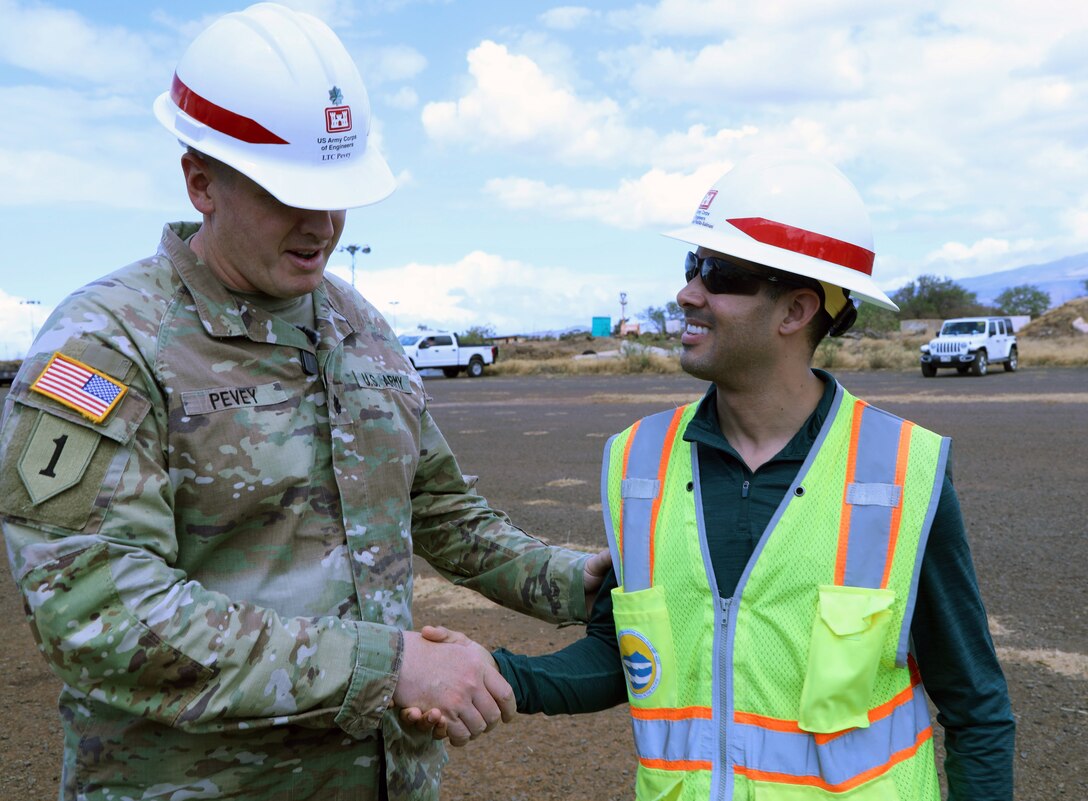 Lt. Col. Ryan C. Pevey, commander, Honolulu District, U.S. Army Corps of Engineers presents a coin to Emmanuel Padilla-Salinas, a logistician, from Honolulu District Power Planning and Response Team on Maui, Aug. 28. The USACE is working with local, state and federal partners on a mission assignment from the Federal Emergency Management Agency in response to the Hawai’i Wildfires.