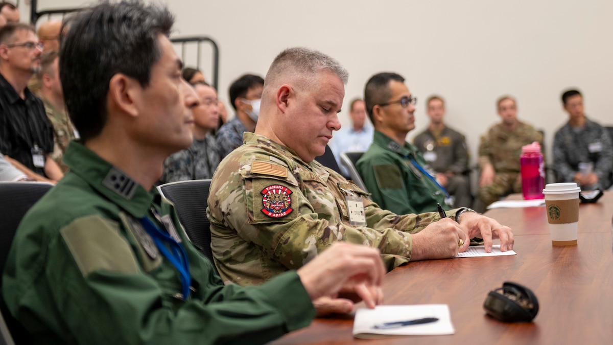Col. Steven Clark (center), Fifth Air Force director of intelligence, makes a note during the opening briefing on the first day of the Far East Tactics Analysis Team conference at Yokota Air Base, Japan, July 24, 2023.