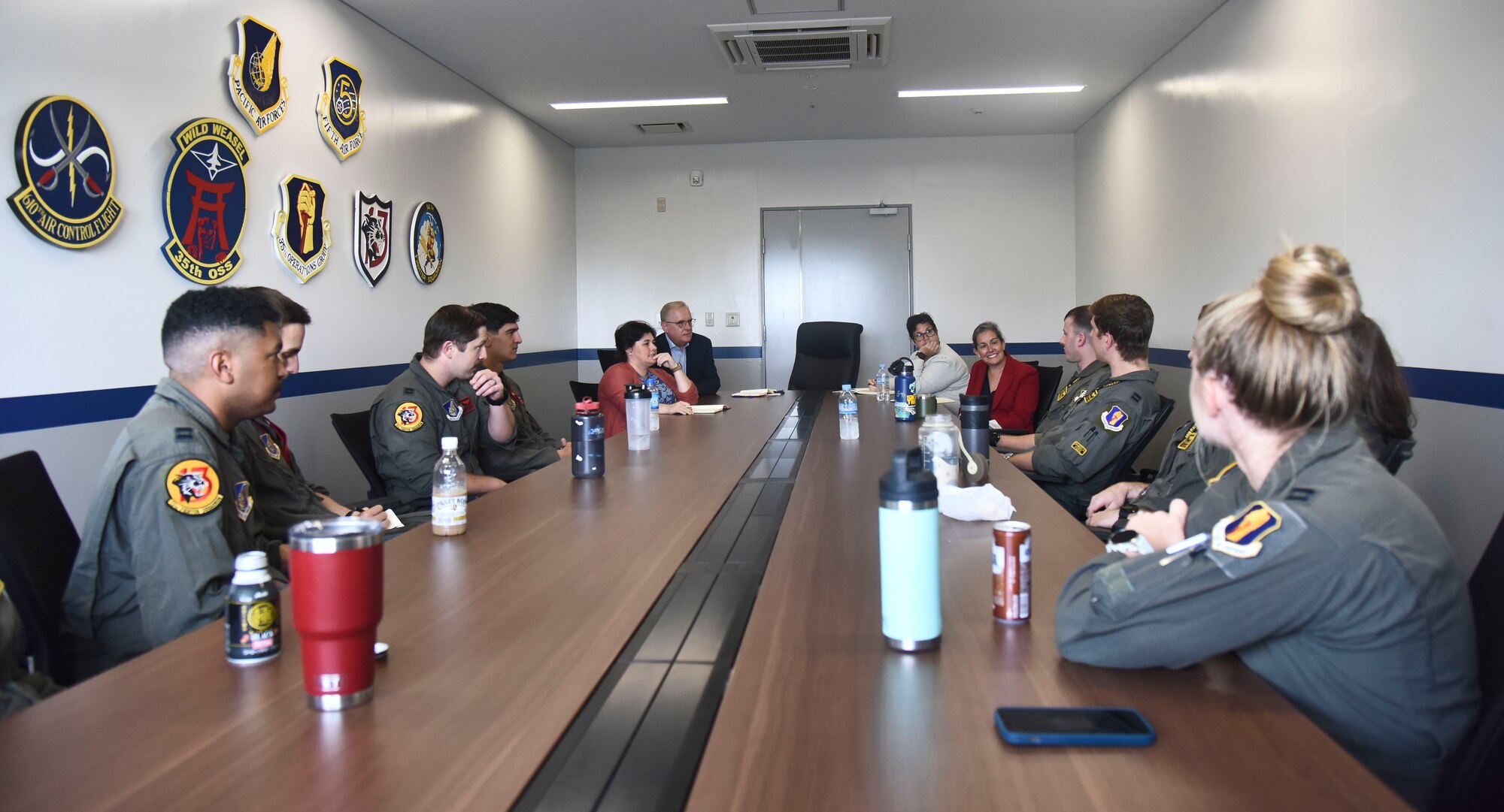 Members of the House Armed Services Committee meet with members of the 35th Operations Group in an aircrew.