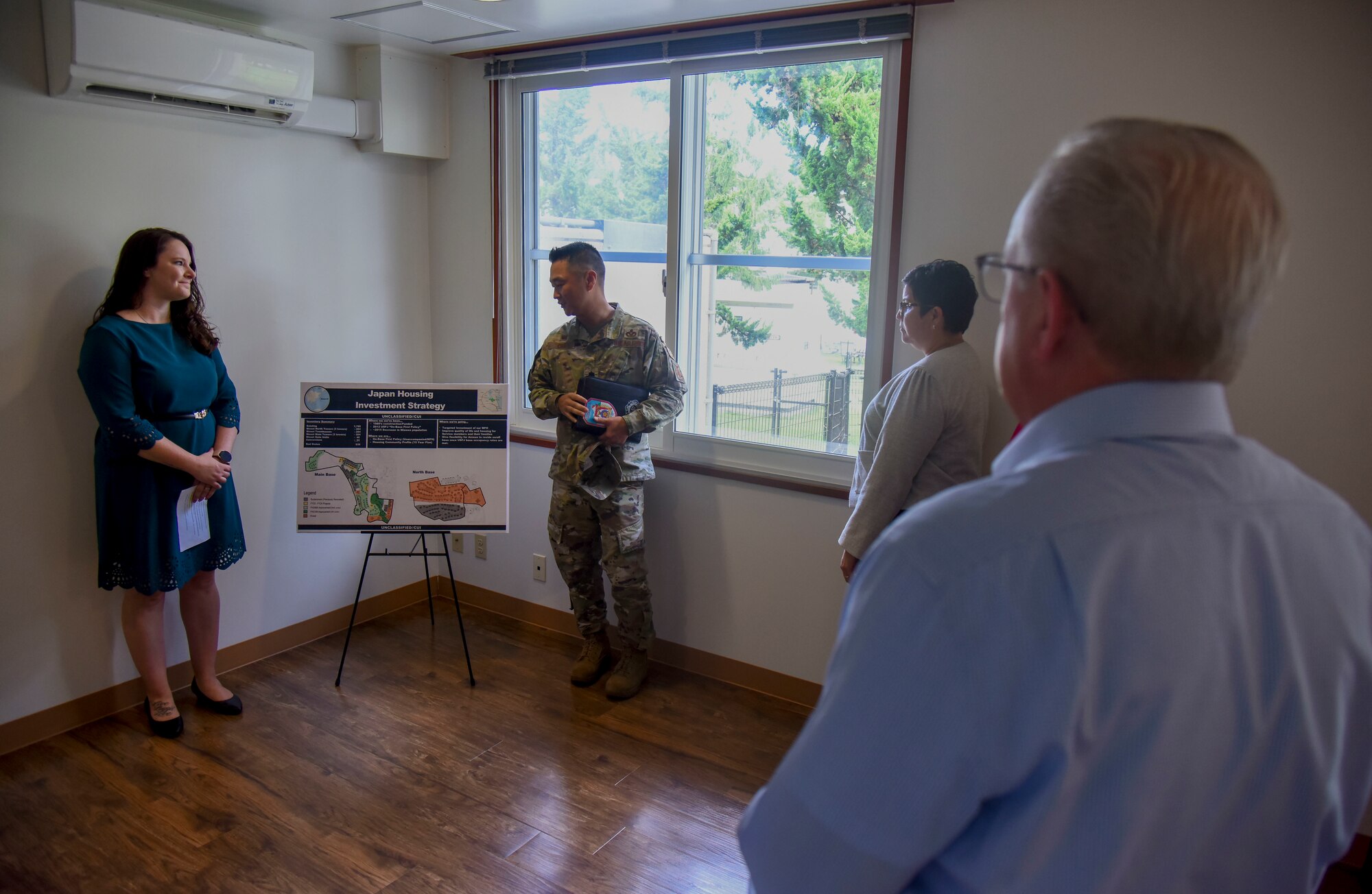 A military member presents a housing outline to members of the House Armed Services Committee.
