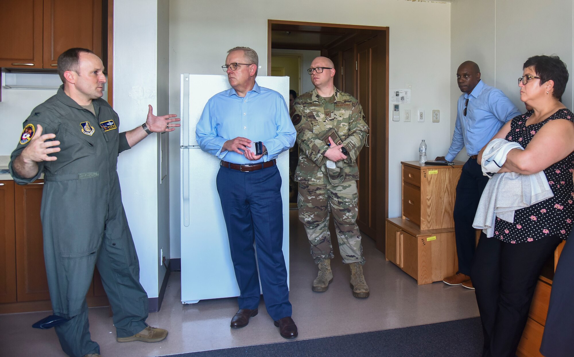 A military member shows House Armed Services Committee members the dorm life of Misawa Airmen.