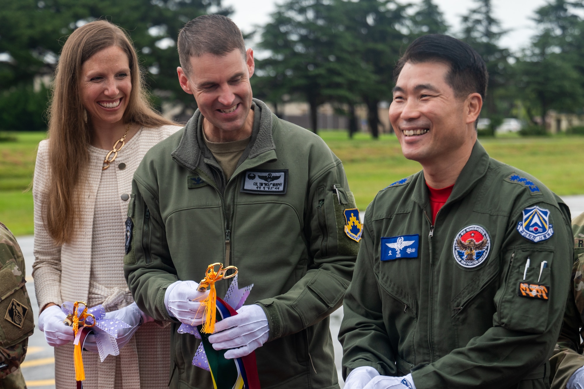 Col. Timothy B. Murphy and Col. Choong-Won Oh share a moment after cutting the ribbon to reopen the flightline.