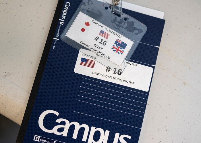 A numbered notebook and event identification badge from the Far East Tactics Analysis Team conference sits on a table at Yokota Air Base, Japan, July 24, 2023.