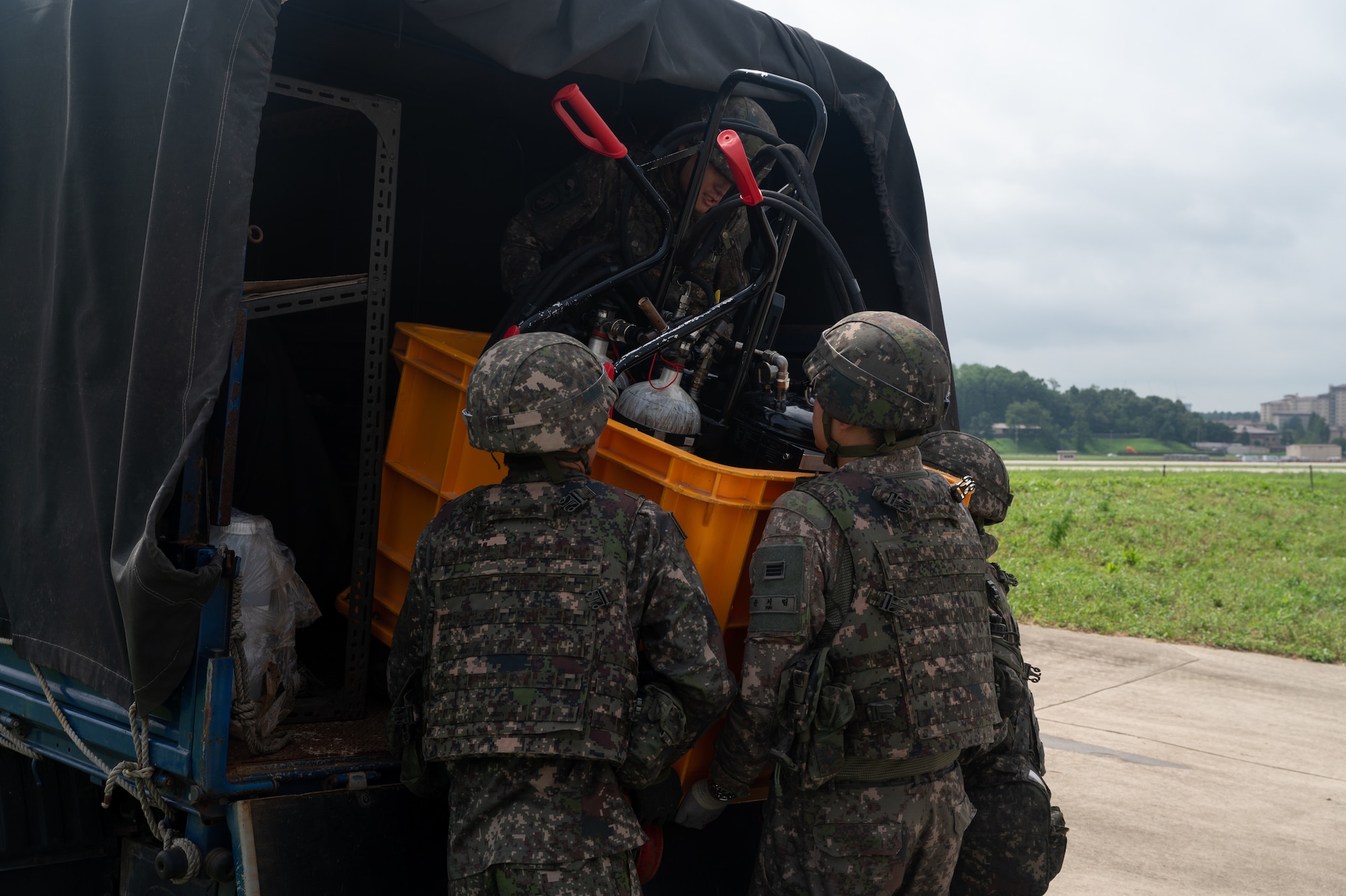 Republic of Korea Army and Air Force service members, unload decontamination equipment during combined forces chemical, biological, radiological and nuclear training with the 51st Civil Engineer Squadron at Osan Air Base, ROK, Aug. 24, 2023. ROK forces provided reconnaissance and decontamination teams to help simulate a real-world response. Joint and combined training like this helps strengthen partnership and enhance cohesiveness with all parties involved. (U.S. Air Force photo by Airman 1st Class Chase Verzaal)