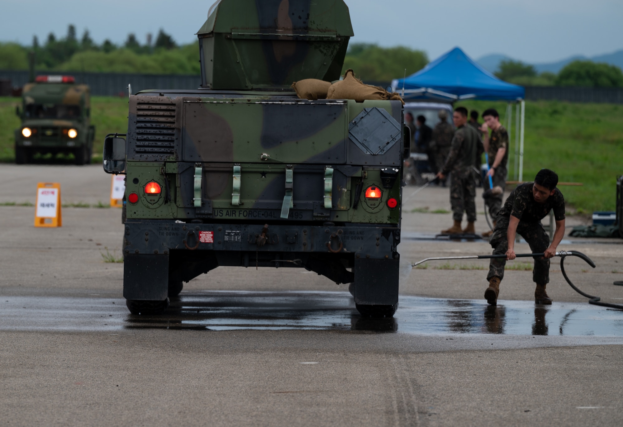 A Republic of Korea Army soldier simulates the decontamination of a U.S. Air Force explosive ordinance disposal vehicle during combined forces chemical, biological, radiological and nuclear training with the 51st Civil Engineer Squadron at Osan Air Base, ROK, Aug. 24, 2023. Practicing CBRN procedures ensures U.S. and ROK forces are prepared and ready to respond to potential real-world threats. (U.S. Air Force photo by Airman 1st Class Chase Verzaal)
